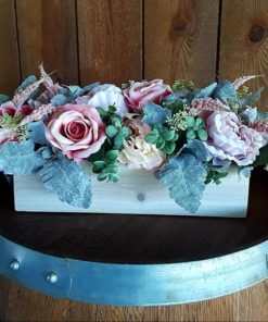 Faux pink flowers in a wooden box